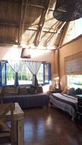a bedroom with two beds in a room with windows at Cabaña de Pez in San Rafael
