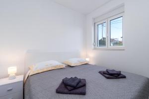 Postel nebo postele na pokoji v ubytování APARTMAN DINO