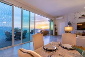 a dining room with a table and views of the ocean at Palacio Blanco Luxury Villa 3 in La Ventana