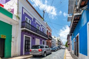 a car parked on a street with colorful buildings at 2-BR Apt centrally located in OSJ! in San Juan
