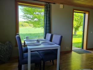 a dining room with a table and chairs and a window at Ekhems Gård in Förslöv