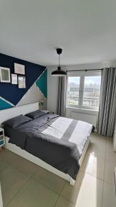 a bedroom with a large bed and a large window at La Casita, Your Home Away from Home - Free Parking in Glasgow