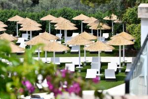 a group of tables and chairs with umbrellas at Salles Hotels Marina Portals in Portals Nous