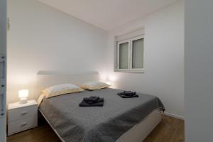Postel nebo postele na pokoji v ubytování APARTMAN DINO