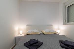 Postel nebo postele na pokoji v ubytování APARTMAN DINO