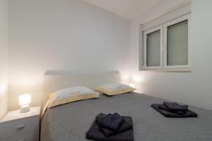 Postel nebo postele na pokoji v ubytování APARTMAN DINO