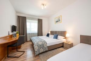 Postel nebo postele na pokoji v ubytování Salzburg Hotel Lilienhof