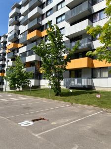 an empty parking lot in front of a building at Vita apartment in Vilnius