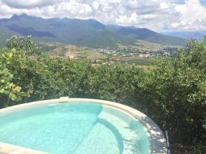a swimming pool with a view of the mountains at Utopia Casas Boutique in Oaxaca City