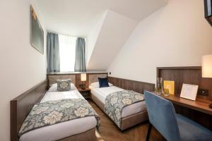 Postel nebo postele na pokoji v ubytování Salzburg Hotel Lilienhof