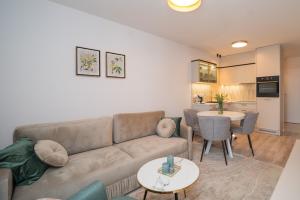 a living room with a couch and a table at APARTAMENT Ceynowa in Kartuzy