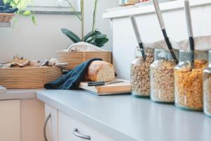 a kitchen counter with jars of food and bread at VICI Hotels Linköping in Linköping +44 photos