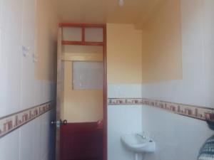 a bathroom with a toilet and a sink at killa andina inn in Puno