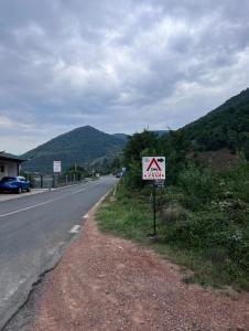 um sinal de aviso na berma de uma estrada em Cabane A-Frame Svinița em Sviniţa