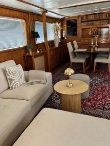 a living room with a couch and a table at Mälardrottningen Yacht Hotel in Stockholm