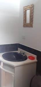 a bathroom with a blue sink and a mirror at Casa campestre en una comunidad ancestrar bajo las faldas del Taita Imbabura in San Juan de Ilumán +33 photos