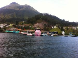 a group of boats in a body of water with a mountain at Casa campestre en una comunidad ancestrar bajo las faldas del Taita Imbabura in San Juan de Ilumán