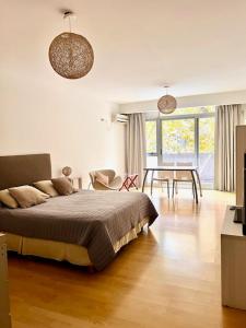 a bedroom with a bed and a table and chairs at Ocio Laprida in Buenos Aires