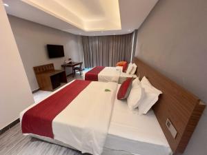 Postel nebo postele na pokoji v ubytování Hotel Omni Residency Baridhara