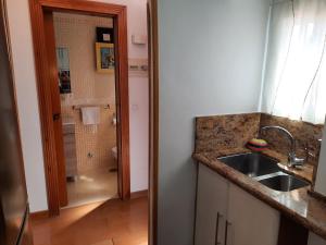 a kitchen with a sink and a shower in a bathroom at Apto a 2 minutos de playa. in Fuengirola +34 photos