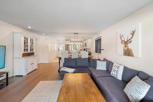 a living room with a couch and a table at Spacious Condo with Lake and Mountain View in Mont-Tremblant