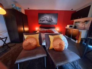 a bedroom with a bed and a red wall at B&B De Voort Venlo in Venlo