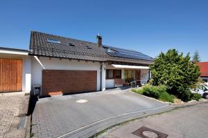 a house with a garage and a driveway at Weiler in den Bergen in Schwäbisch Gmünd