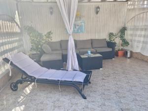 a living room with a couch and a table at White Rose Guest Rooms in Burgas