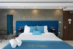 A bed or beds in a room at THE OSiRiS