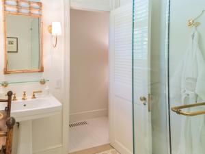 a bathroom with a shower and a sink at Eleven Bahama House in Harbour Island
