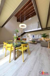 a living room with a yellow table and yellow chairs at B&B Cubbaita in Palermo