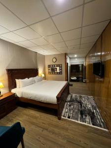 a bedroom with a bed and a television in it at Infinity Villa and Resort Kumrat Valley in Tāl