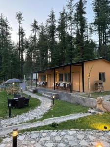 a house with a stone path leading to it at Infinity Villa and Resort Kumrat Valley in Tāl