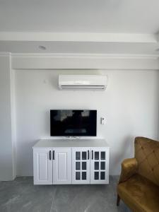 a living room with a white tv and a couch at The Dalaman Suites & Pansiyon in Dalaman