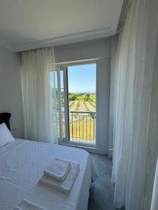 a bedroom with a bed and a large window at The Dalaman Suites & Pansiyon in Dalaman