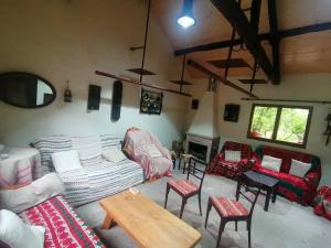 a living room with couches and chairs and a table at Aldea Rural Santo André in Congostro