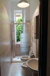 a bathroom with three toilets and a window at Domo Nina in La Spezia