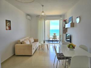 a living room with a couch and a table at Sea Vista Apartment in Durrës