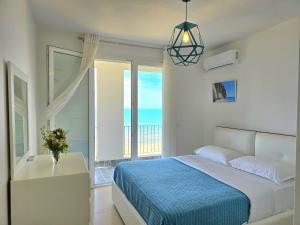 a bedroom with a bed and a view of the ocean at Sea Vista Apartment in Durrës
