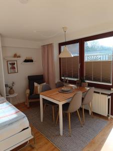 a living room with a table and chairs and a bed at Appartement Plögemaker in Süsel