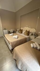 a hotel room with two beds with towels on them at Fuoco dell'Etna in Catania