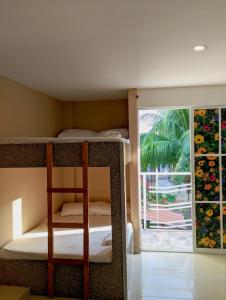 a bedroom with a bunk bed and a window at Villa Cabana Inn in Playa Dormida