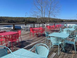 a bunch of tables and chairs on a deck at Moon River Marina & Resort in Cadiz