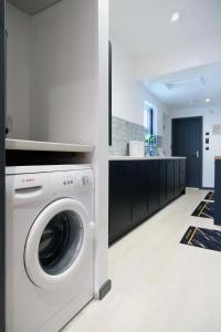 a white washer and dryer in a kitchen at Breckfield House by Serviced Living Liverpool in Liverpool