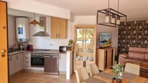 a kitchen with a table and a dining room at Le Casa del Sol de Marta in Manilva