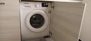 - un lave-linge dans une chambre avec porte dans l'établissement CASA MARE, à Gênes
