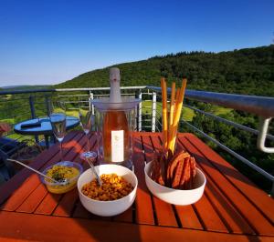 a table with bowls of food on a balcony at Haus Burgsponheim in Burgsponheim