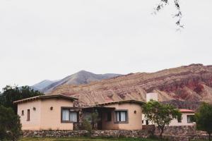 a house with mountains in the background at Casas de Juella in Tilcara