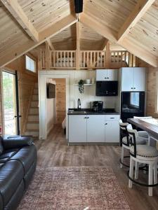 a kitchen and living room in a log cabin at The Bellefonte Campground in Bellefonte