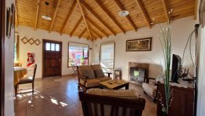 a living room with a couch and a fireplace at Peggy´s House in Puerto San Julián